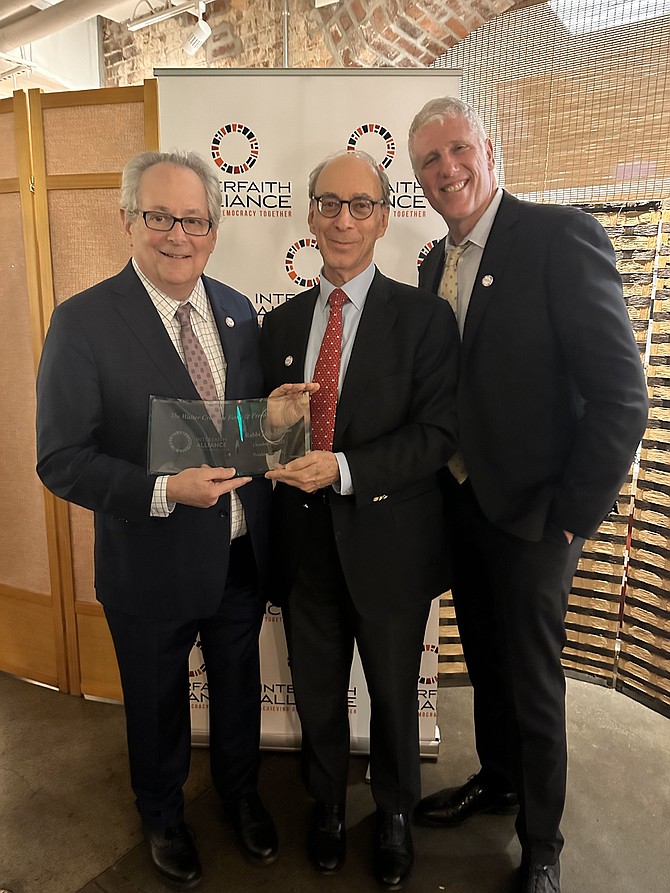 Rabbi Jack Moline, left, receives the Walter Cronkite Faith and Freedom Award from Interfaith Alliance chair Jacob Worenklein and president Paul Raushenbush Oct. 18 at the Immigrant Food Planet Word Museum.