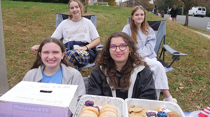 Yorktown High School students sit outside the polling place at Madison Community Center selling baked goods to raise funds for their Model General Assembly in Richmond to be held in the spring. Back left to right: Allison Larmee, Virginia Lewis. Front left to right: Olivia Plimpton, Lia Sylvester.