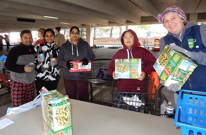 Working together are (from left) twins Madhavan and Meena Kandagatla, Chantilly High sophomores; Sowjanya Pulipati of Chantilly; Landon Park of Boy Scout Troop 44; and Centreville’s Brandice Roberts of Girl Scout Troop 3327.