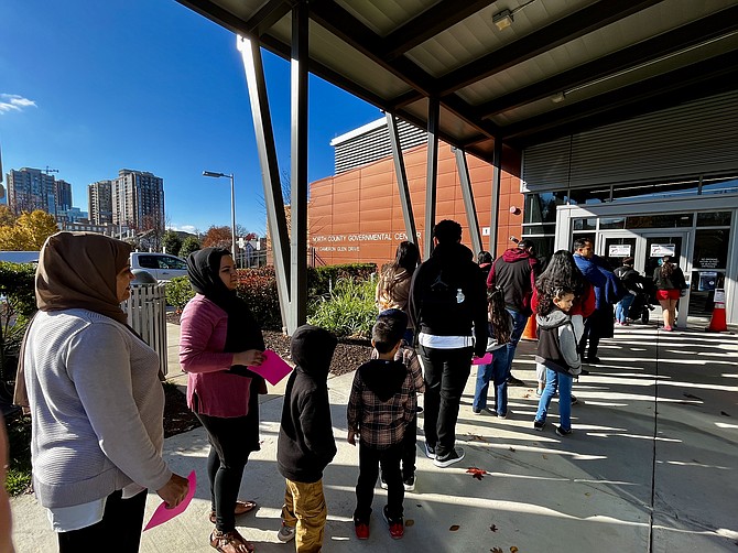 Within the line of sight to Reston Town Center's luxury condos, families and individuals in need line up for free winter wear at the North County Government Center.