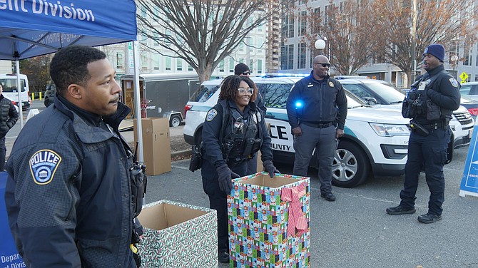 ACPD officers set up a Community Engagement tent in the Central Library parking lot Saturday afternoon as part of the Ninth Annual Fill the Cruiser Toy Drive.