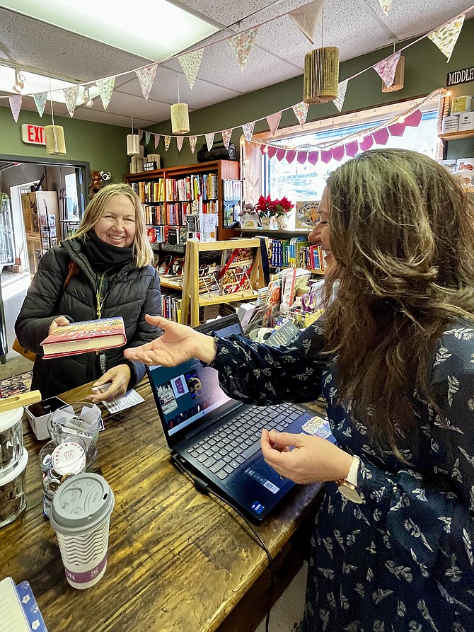 Donna Lawrence of Fairfax shopping with help from Beth Luke, co-owner of A Thousand Stories in Herndon, as the indie bookstore celebrates its first birthday. A Thousand Stories held its Grand Opening on Small Business Saturday, 2022.