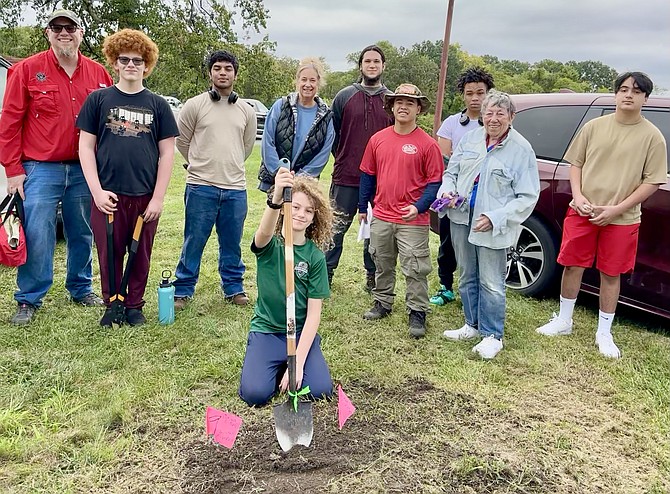 The ‘burial party’ volunteers, Will and Liam Pennell, Susan and Jeremy Freewalt, Matthew Wang, Jaquan Marin, Joan McGowan, Jady Colley, and Remmy Pennell (center), interred cotton undies (actually baby’s onesies) in two locations on Sept. 30