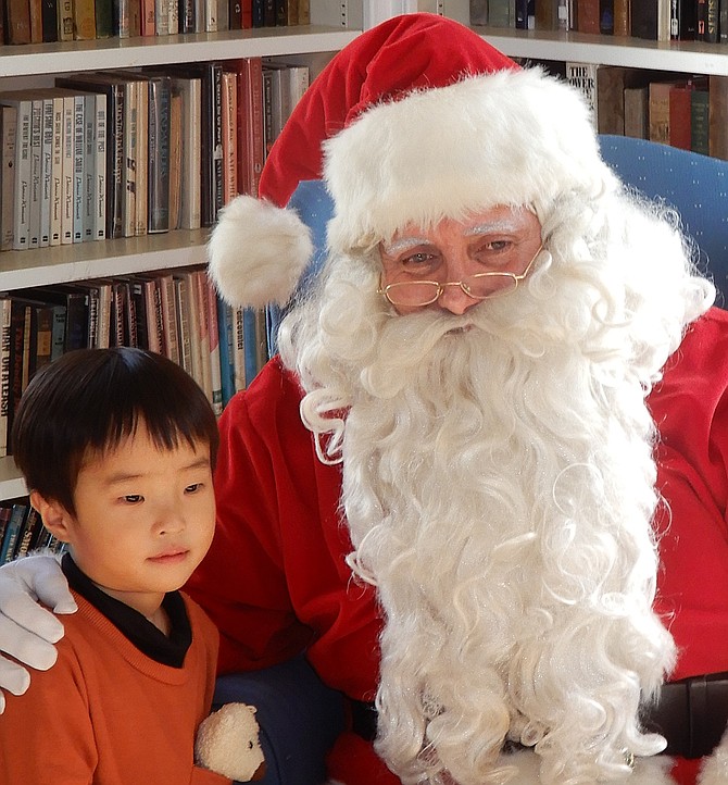 Roy Yang, 3, and Santa are both in a pensive mood.