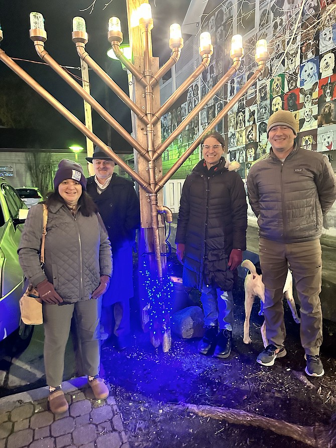 A group celebrates the fifth night of Hanukkah Dec. 12 at Pat Miller Neighborhood Square. Known as the Festival of Lights, Hanukkah 2023 began Dec. 7 and ends Dec. 15.