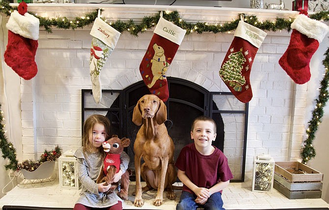 Christmas stockings - Family members of all ages, like Kayla, Callie, and Zack Barger, of Annandale, hang stockings on the mantle where Santa can’t miss them, eager to check them on Christmas morning.