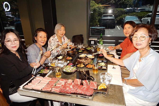 Enjoying their feast are (clockwise from left) two people named Anna Ko, Wanda Park, Maria Han and Hae Kim.