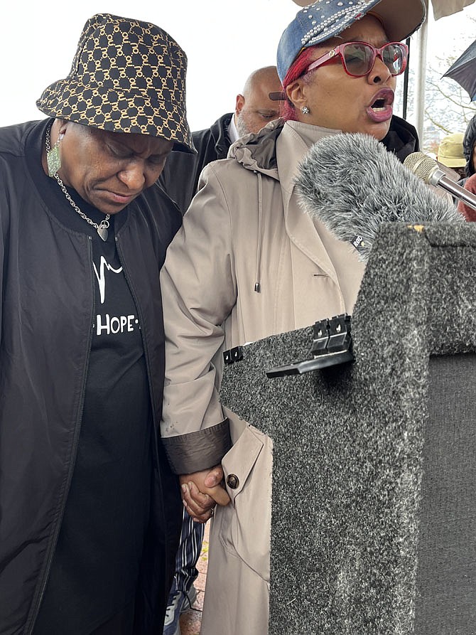 Fairfax NAACP President Michelle Leete, right, at a vigil for Timothy Johnson in April 2023. Johnson was shot dead by Fairfax County police. Leete  grips the hand of Johnson’s mother, Melissa. Leete died unexpectedly last week.
