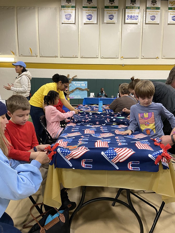 From left, Will Russell, 6, of Burke; Raylan Weeks, 7, of Springfield; and Harper Reid, 10, of Alexandria, have mastered the art of no-sew blankets for veterans. Volunteers made 60 blankets for Capital Caring Health to distribute to veterans in hospice care.