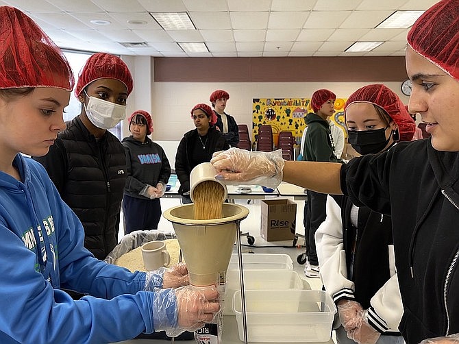 In 2023, Patrecia Anjum, 17, Analiese Jones, 15, Izzy Ahad, 16, and Emily Pham, 18, members of the Herndon High School Interact Club, took part in the meal packaging event for Rise Against Hunger.  (File photo)