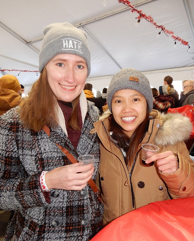 Jessica Ostrowski-Wright (left) and Anh Pham enjoy, respectively, a chocolate hazelnut truffle drink and a cherry chocolate stout beer at 2023’s Liquid Chocolate.