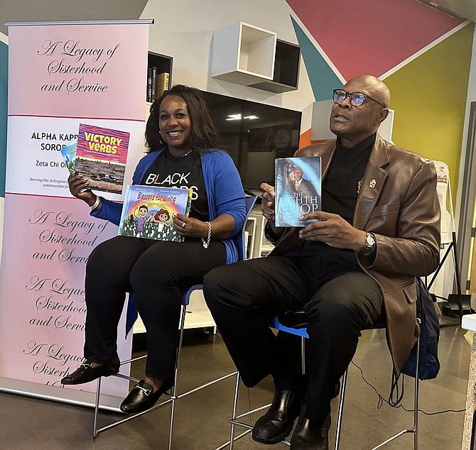 Authors Elana M. Neely and Dr. Willie H. Smith hold up copies of their books at the MLK Day Book Nook Dedication and Book Give-Away Jan. 13 at Charles Houston Recreation Center.