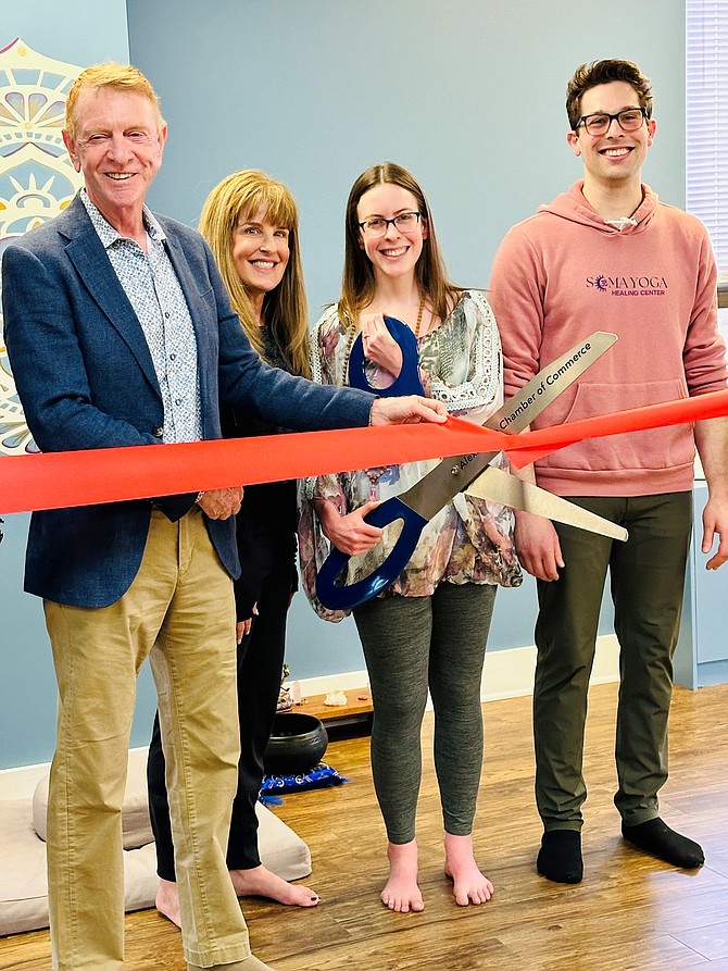 Ribbon Cutting for Soma Yoga Healing Center. From left, Joe Haggerty, CEO, Alexandria Chamber of Commerce; Tracie Brace, also known as Padma, owns Rasa Yoga in Houston, Texas; Sarah Deblock, owner Soma Yoga Healing Center, Sarah’s  husband Ryan Deblock. Brace is Sarah Deblock’s mentor and came from Texas to celebrate.