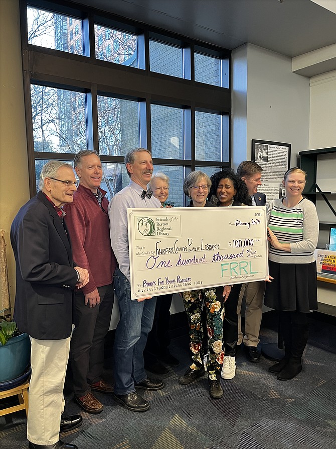 During the recent Mystery and Thriller Book Sale at Reston Regional Library, the Friends of the Reston Regional Library present the $100,000 check to FCPL Director Jessica Hudson, representatives from the Collection Services Department, and Hunter Mill Supervisor Walter Alcorn.