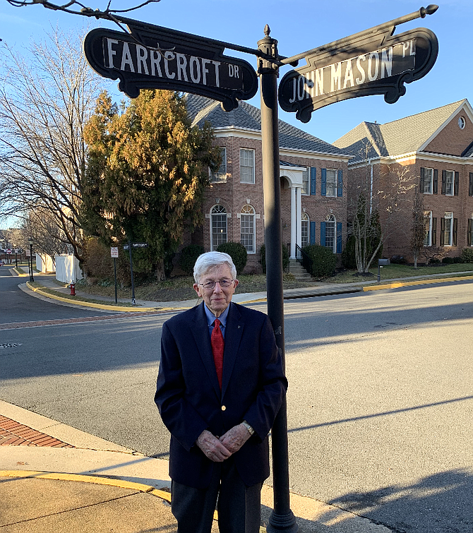 John Mason standing at the corner of Farrcroft Drive and John Mason Place in Fairfax.