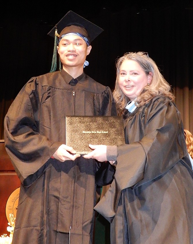 Jayvin Luangraj with his diploma from Principal Stone.
