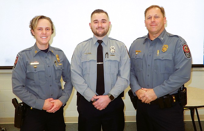 PFC Jacob Juranek is flanked by Capt. Jane Russell, station commander, and Lt. Ryan Low, assistant station commander.