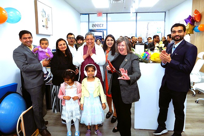 Celebrating after the ribbon cutting are (from left) Jignesh and Kruti Lakhani with daughter Diya, 1-1/2; Gaurang Gandhi (with glasses) and son Aavyan, 1; Shalini Varshney, Shital Gandhi, Kathy Smith and Lakhani’s brother Abhi. (Front row, from left) are Aarya Gandhi, 4 (Gaurang and Shital’s daughter) and Granthi Lakhani, 6 (Jignesh and Kruti’s daughter).
