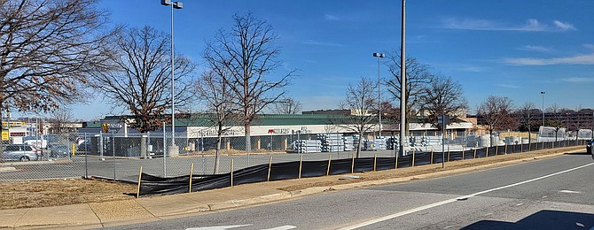 Looking north from Spring Mall Drive, part of the parking lot is sectioned off for the storage of construction materials that will be used in the redevelopment project.