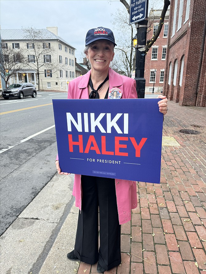 Volunteer Kelly Currie stands outside the City Hall polling station in support of Republican presidential candidate Nikki Haley March 5.