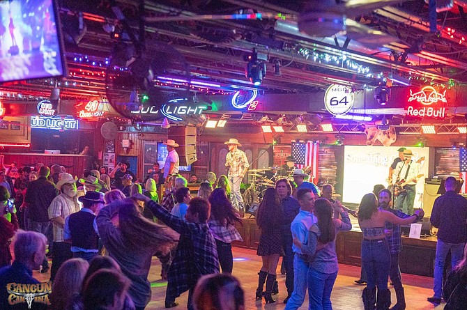 Line dancing  is a big part of the country music experience.