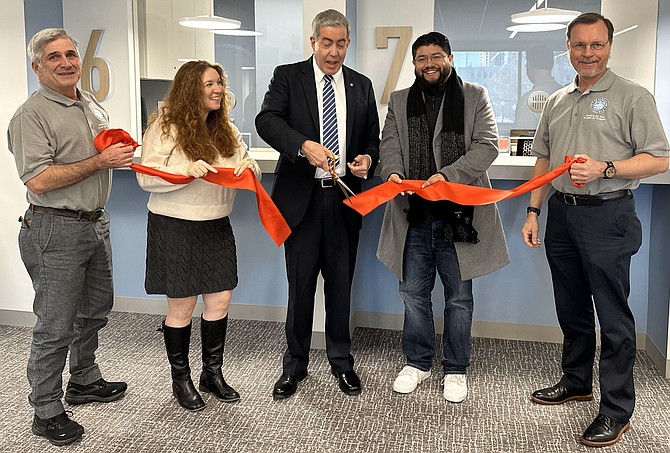 Alexandria Clerk of Court Greg Parks, center, cuts the ribbon to officially open the West End Service Center of the Alexandria Clerk of Circuit Court March 12 at the Redella S. “Del” Pepper Community Resource Center. With Parks are Brian Vanfleet, City Council members Sarah Bagley and Canuk Aguirre, and John Knippenberg.