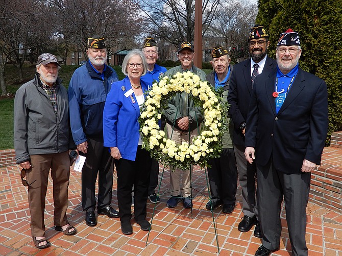 Veterans standing with the memorial wreath are (from left) David Gundry, Mike Fant, Cherie Fuchs, Link Spann, James Johnston, John Weaver, Ahsan Nasar and Mac Carl.