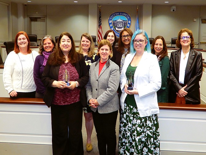 Commission for Women members pose with the mayor and the honorees. Back row, from left are Mary Baker-Mezlo, Lisa Whetzel, Teresa Byrne, Taylor Geaghan, Simmy King, Mena Crawford and Lesley Abashian, Fairfax Human Services director. Front row, from left are Lorraine Koury, Catherine Read and Kelly O’Brien.