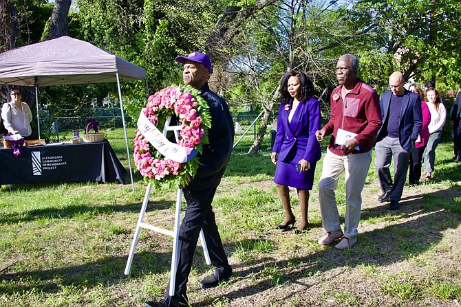 Alexandria Community Remembrance Project member McArthur Myers leads the procession for the wreath laying ceremony to mark the 127th anniversary of the lynching of Joseph McCoy April 23 at Penny Hill Cemetery.