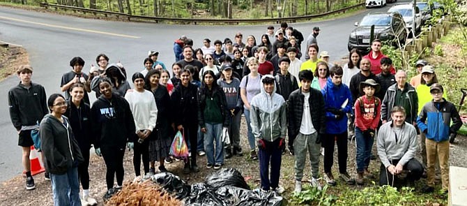 Sixty volunteers at Difficult Run Stream Valley Park, in Oaken, remove bags of invasive plants and trash to promote water quality and native plant life