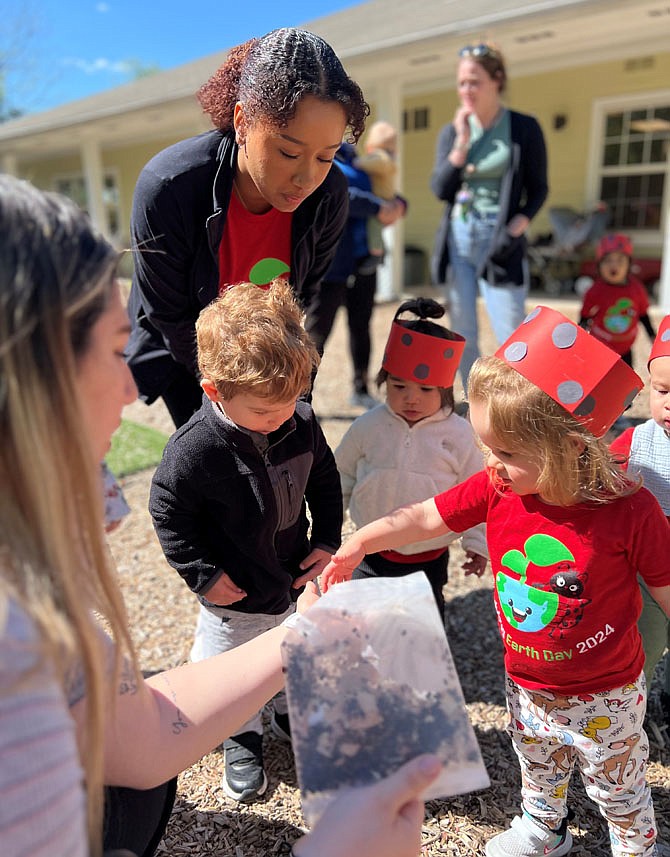Chesterbrook teacher Ms. Samantha helps students release some ladybugs.