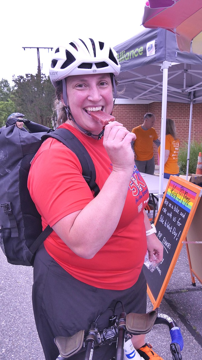 Anne Forney takes a popsicle break at the bike stop off the trail at Lyon Village on Langston Blvd.