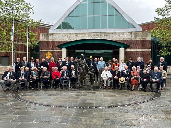 Members of the West Point class of 1959 are joined by their spouses and children during a visit to the Capt. Rocky Versace Plaza and Vietnam Memorial April 27 in Del Ray. Versace, a Medal of Honor recipient and Vietnam War POW/MIA, was a 1959 West Point graduate.