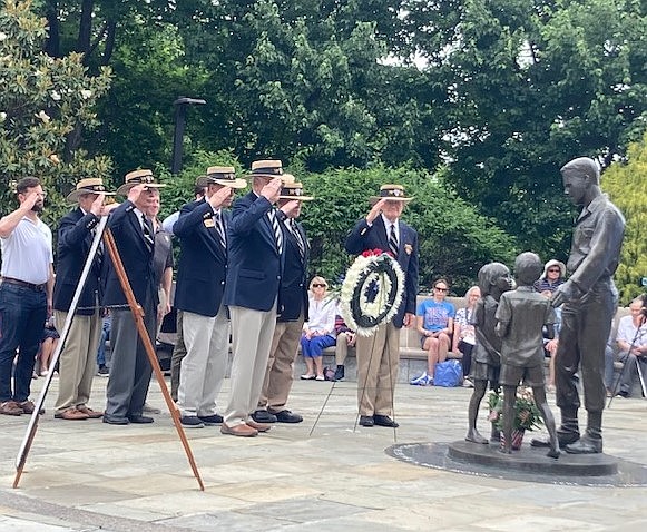 USMA 1959 classmates of Capt. Humbert “Rocky” Versace salute after presenting a wreath at his statue during the sounding of Taps May 27 at the Vietnam Veterans Memorial in Del Ray.
Photo by Allison Silberberg