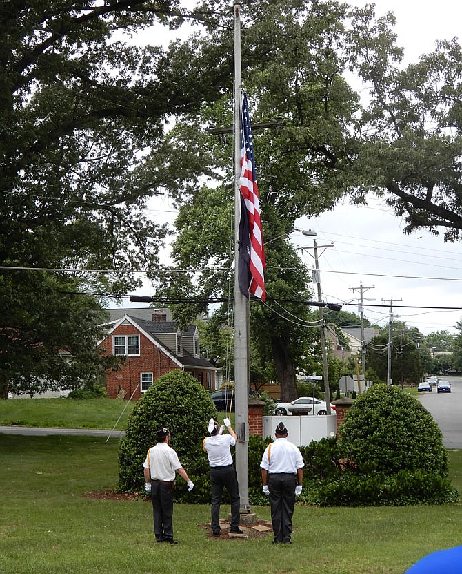 At noon, veterans raised the flag from half staff to the top of the flagpole.