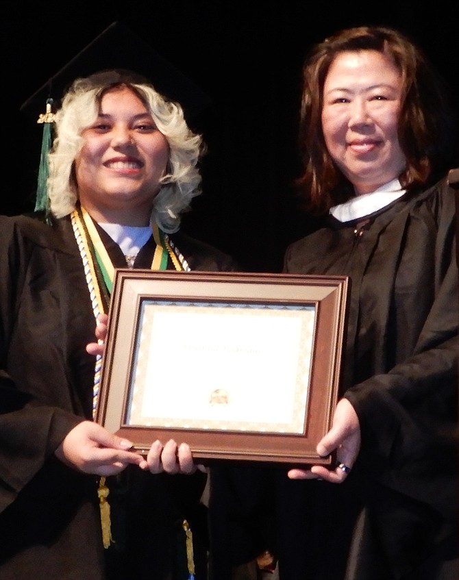 From left, Brianna Rodriguez receives the Citizenship Award from teacher May Ko.