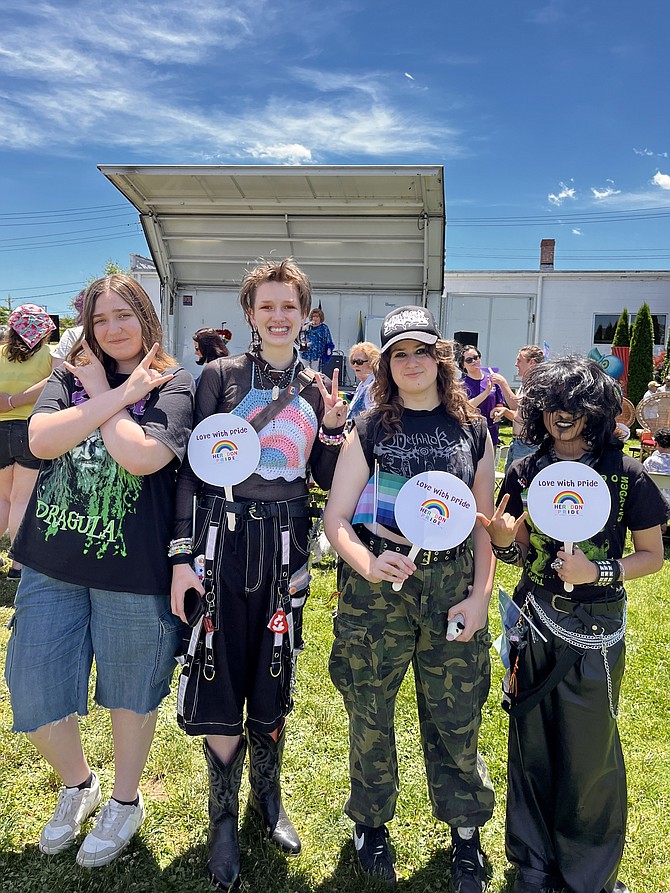 From left, friends Ruby Chernowetz, Tam Anthony, Toki Cabera and Dante Bimbra gather in front of the performance stage at the inaugural Herndon Pride Festival held on Saturday, June 12.