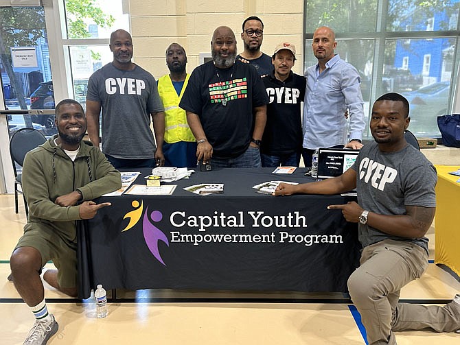 Everette Boobie Mitchell, center, stands with members of the Capital Youth Empowerment Program, a sponsor of the Men’s Health Empowerment Expo June 8 at Charles Houston Recreation Center.