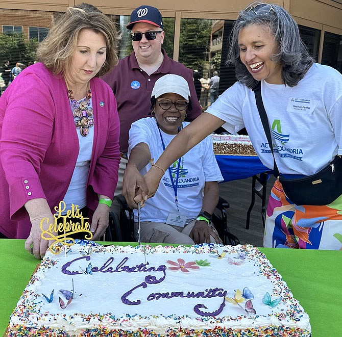 ACT president and CEO Heather Peeler, right, is joined by vice Mayor Amy Jackson, Councilman Kirk McPike and former Deputy City Manager Debra Collins in cutting a cake to celebrate the 20th anniversary of ACT for Alexandria June 8 at Canal Center Plaza.