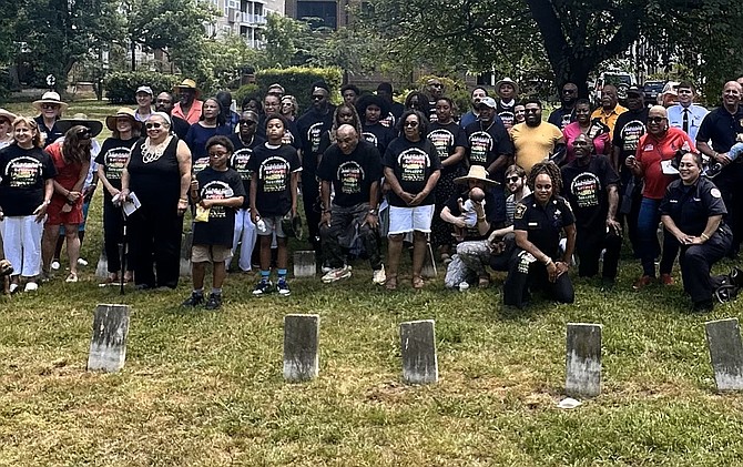 Guests and descendants of those buried in Douglass Memorial Cemetery gather for a photo at the Douglass Cemetery Juneteenth Remembrance ceremony June 15.