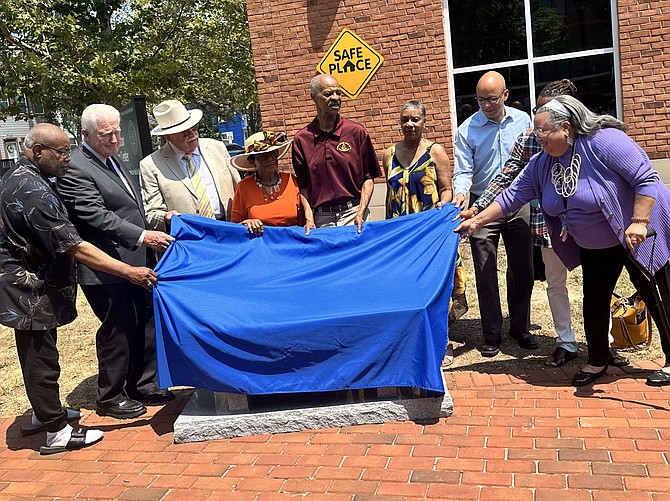 McArthur Myers, center, is joined by local dignitaries in unveiling a bench dedicated to Martin Luther King Jr. June 22 at Charles Houston Recreation Center. Myers and former George Washington Masonic National Memorial executive director George Seghers, third from left, donated the bench in memory of the slain Civil Rights leader.