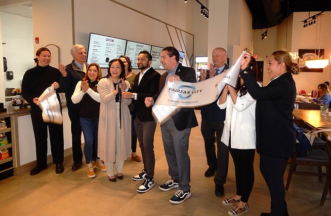 Celebrating the ribbon cutting of The Commons Fooderie: In center are Hanna and Usman Saleem (with scissors) and Jon Stehle.