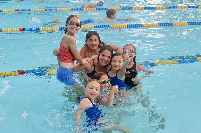 Swim team members celebrate as the Sharkfest Community Fundraiser Tops $10,000.