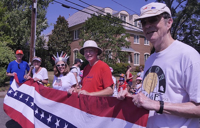 The traditional red, white and blue street banner is carried by many of the regulars in the Lyon Village neighborhood.