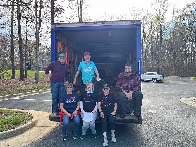 Gracing Spaces volunteers in the back of the one truck they own.