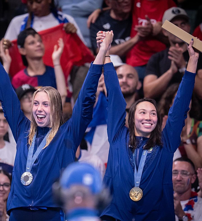 Torri Huske, right wearing gold, and teammate Gretchen Walsh with silver.