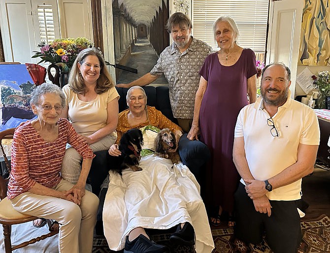 Marian Van Landingham, seated center, is surrounded by friends to celebrate 50 years of the founding of the Torpedo Factory as an art center July 13 at her home in Old Town.