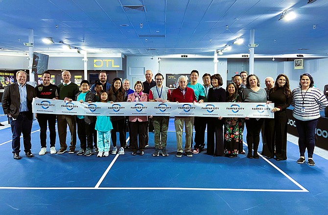 Participants pose for a photo before cutting the ribbon. Chris Bruno is at far left, Catherine Read is in the center (in pink jacket) and Tara Borwey is at far right.