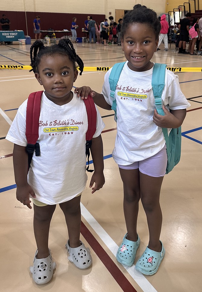 Sisters Gabriella Carr (left) and Calarda Williams model their new backpacks at Charles Houston Recreation Center