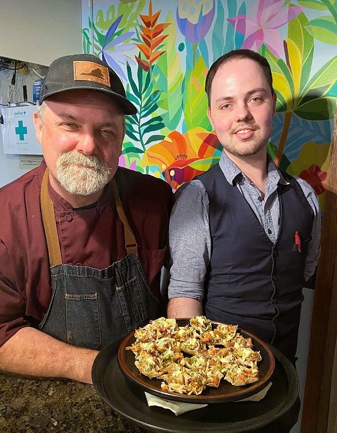 Father and son Chris and Zack Savage, with appetizer-sized tostadas with Peruvian chicken, pico de gallo and Salvadoran crema.